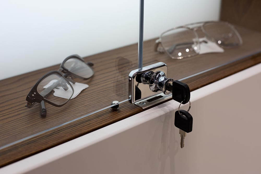 glass cabinet with glasses behind closed transparent doors